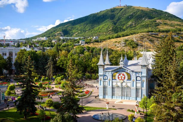 Landscape of Pyatigorsk, Stavropol Krai, Russia. Scenery of park Flower Garden on Mashuk Mountain background. Scenic view of Lermontov Gallery, historical landmark of Pyatigorsk installed in 1901